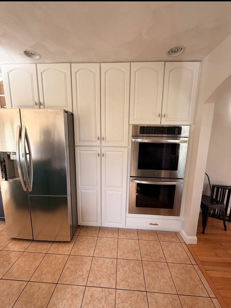 Kitchen Cabinet Painting – After 4 White painted pantry and wall oven cabinets after kitchen cabinet refinishing