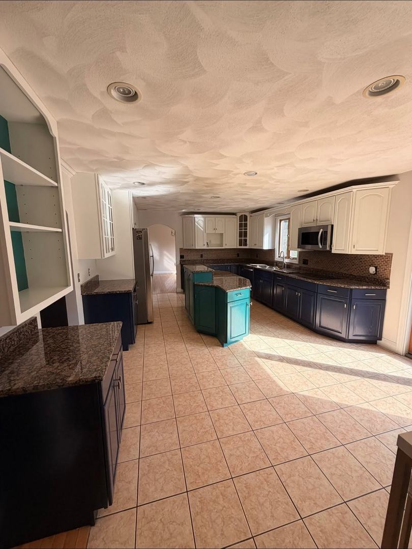 Kitchen Cabinet Painting – After 6 Full kitchen view showing white, navy, and teal painted cabinets after refinishing