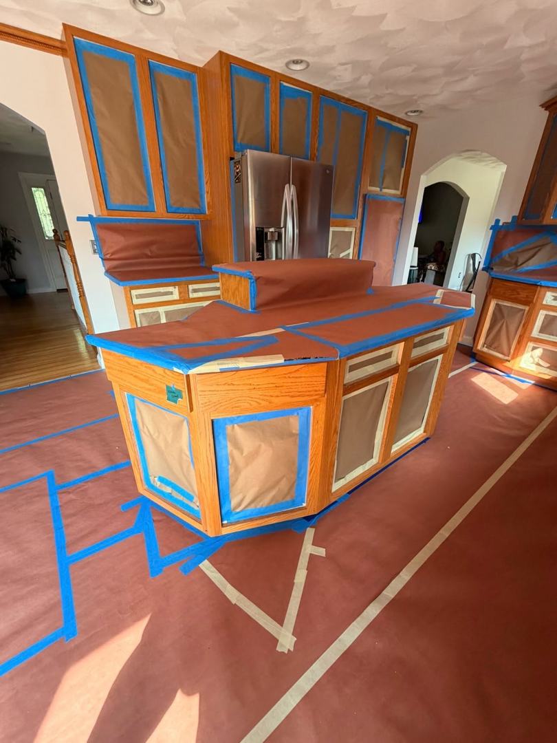 Kitchen Cabinet Painting – Before 2 Oak kitchen island and cabinets taped and prepped before spray painting